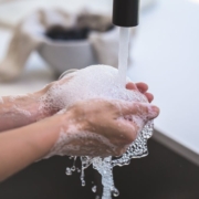 Washing hands in sink with soap to kill germs